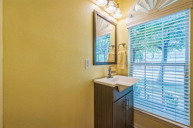 Bathroom featuring a textured wall and vanity | Image 20