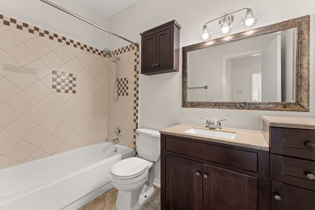 Bathroom featuring vanity, tile patterned floors, toilet, and shower / bathtub combination | Image 21