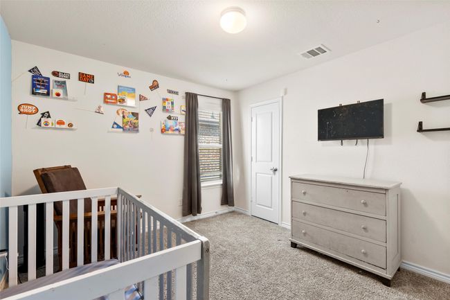 Bedroom with baseboards, visible vents, carpet, and a nursery area | Image 25