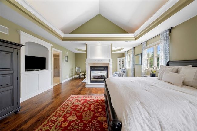 A built-in entertainment center is provided in this spacious suite with beautiful hardwood gracing the floors. | Image 23