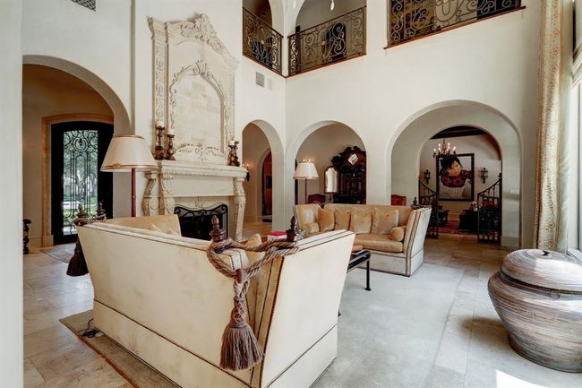 Another view of the formal living area that has custom gates leading to the den and kitchen. | Image 8