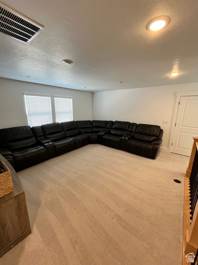 Living room with carpet, a textured ceiling, and recessed lighting | Image 12