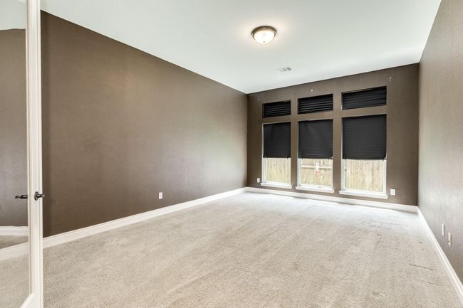 The media room has blackout curtains to fully optimize movie watching. There are three large windows in the room, so if you are using it as a flex room, you will get plenty of natural light. | Image 13