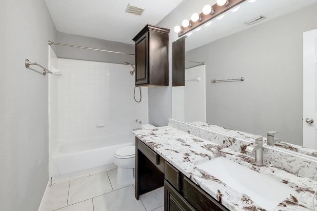 Full bathroom with vanity, visible vents, toilet, and tub / shower combination | Image 30