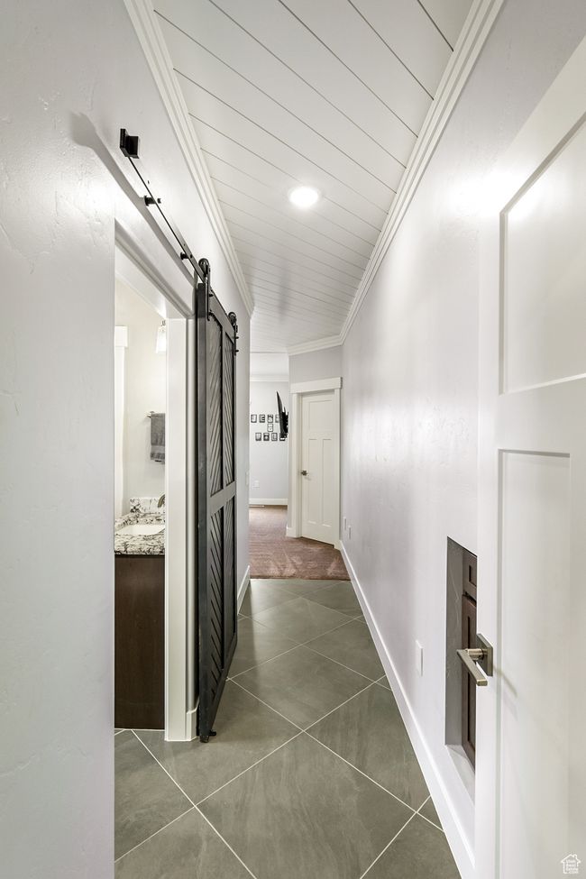 Hallway with a barn door and crown molding | Image 37