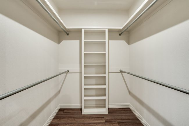 Spacious closet with dark wood-style floors | Image 17