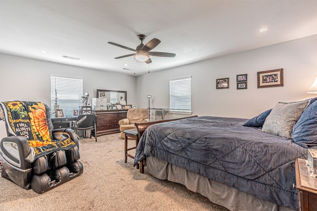Bedroom featuring carpet floors, a ceiling fan, multiple windows, and recessed lighting | Image 19