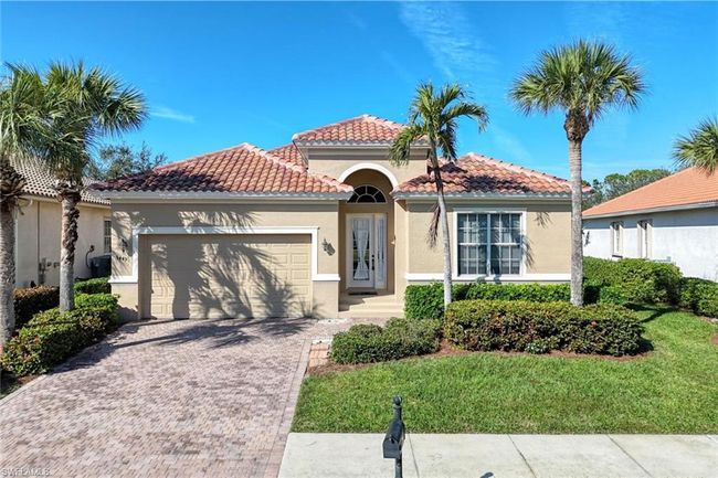 Mediterranean / spanish house featuring a garage and a front lawn | Image 43