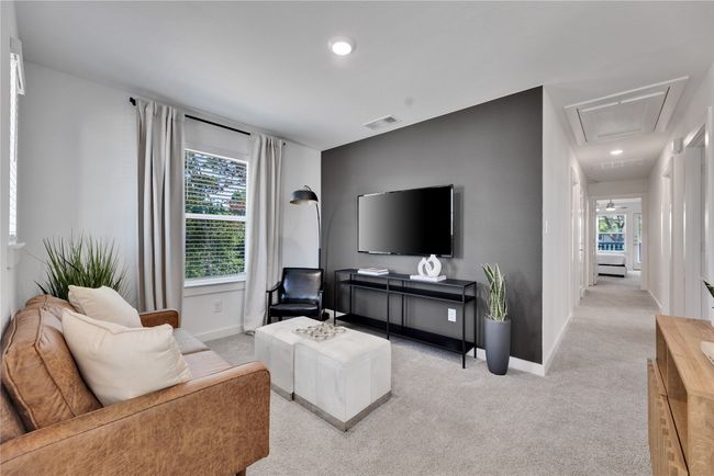 Carpeted living area with attic access, recessed lighting, visible vents, and baseboards | Image 7