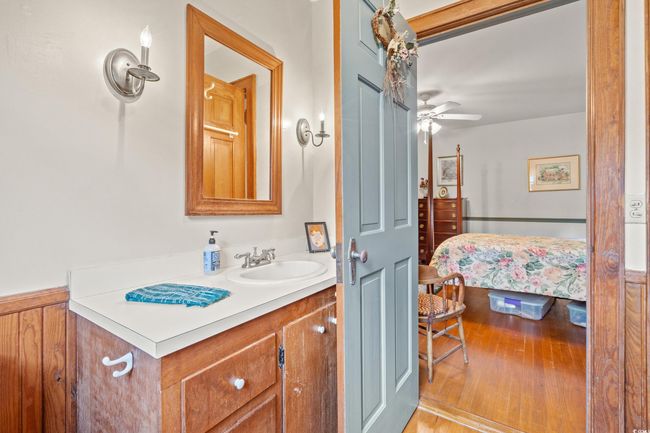 Ensuite bathroom featuring vanity, wood finished floors, and a ceiling fan | Image 16