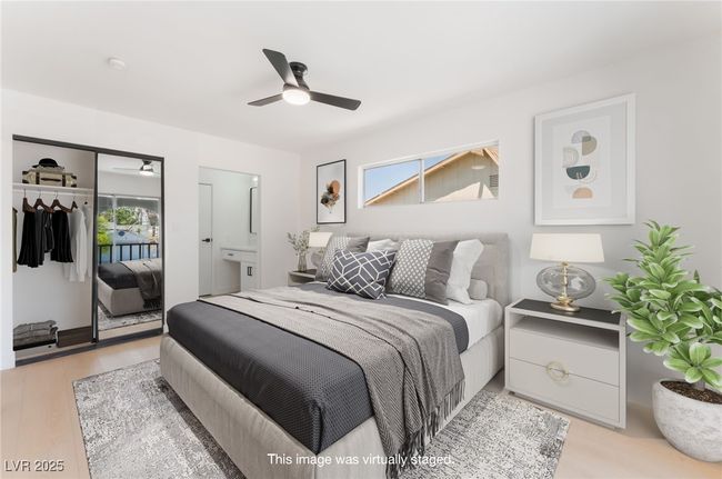 Bedroom with light wood-style flooring, a ceiling fan, and ensuite bathroom | Image 29