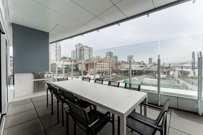 Balcony featuring a view of city and outdoor dining area | Image 27