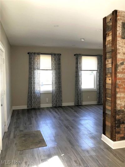 Entry & Living area featuring LVT & exposed brick | Image 3