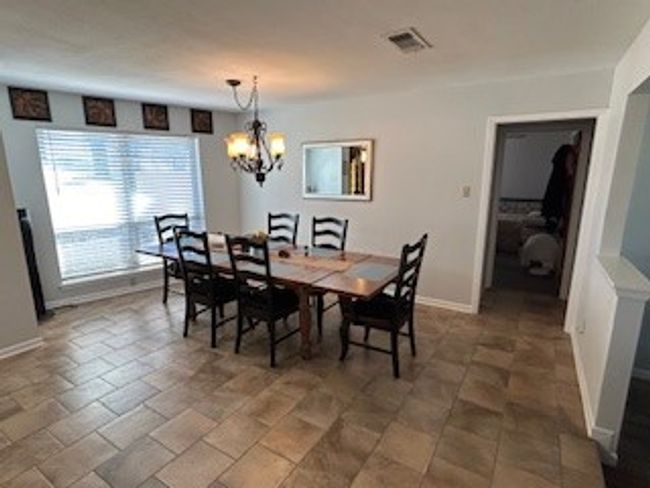Dining room featuring a chandelier and baseboards | Image 11