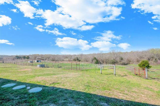 View of yard with a rural view and fence | Image 37