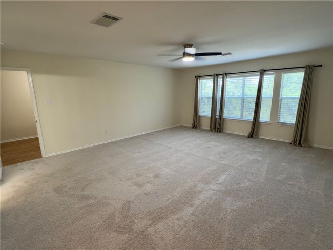 Carpeted spare room with ceiling fan and baseboards | Image 21