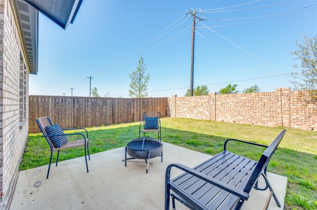 View of patio featuring a fenced backyard and a fire pit | Image 20