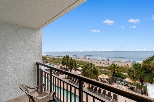 Balcony with view of water and beach | Image 12