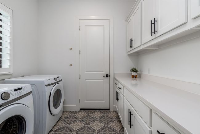 Laundry Room downstairs with plenty of storage area | Image 31