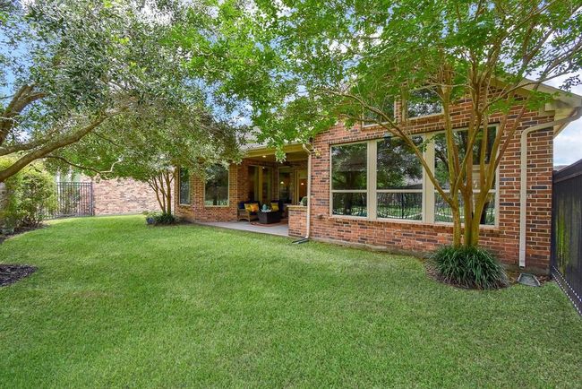 The backyard has a sprinkler system to maintain the beautiful lush landlscape. | Image 40