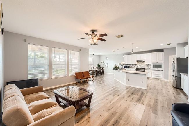 Spacious open-concept living, dining, and kitchen area—perfect for modern living and entertaining. | Image 13