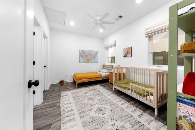Bedroom featuring a ceiling fan, wood finished floors, baseboards, visible vents, and recessed lighting | Image 27
