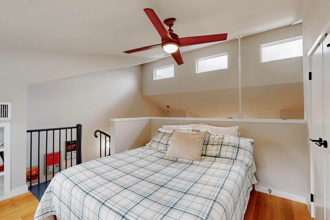 Bedroom featuring multiple windows, wood finished floors, and baseboards | Image 20