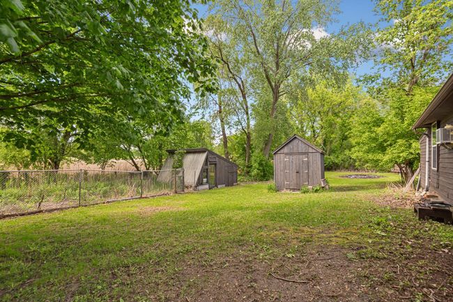 2 outbuildings, 1 is a greenhouse and the other one is a storage shed. | Image 8