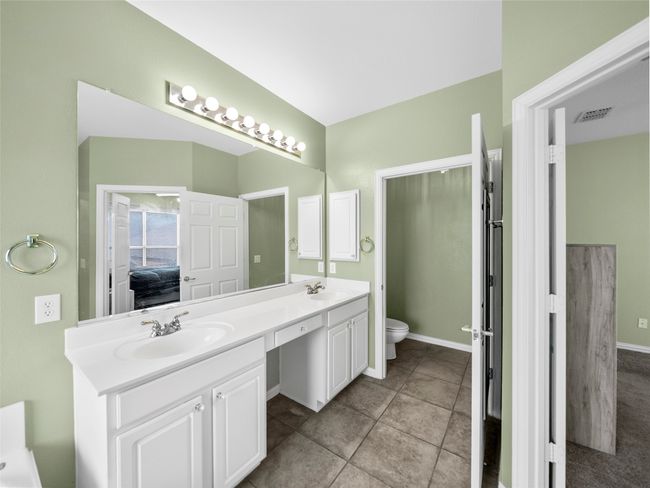 Ensuite bathroom with visible vents, double vanity, a sink, and toilet | Image 19