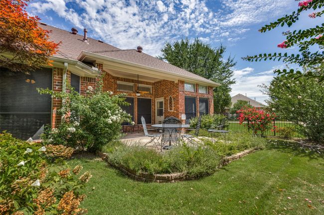 Rear view of house featuring brick siding, a patio, ceiling fan, and roof with shingles | Image 22