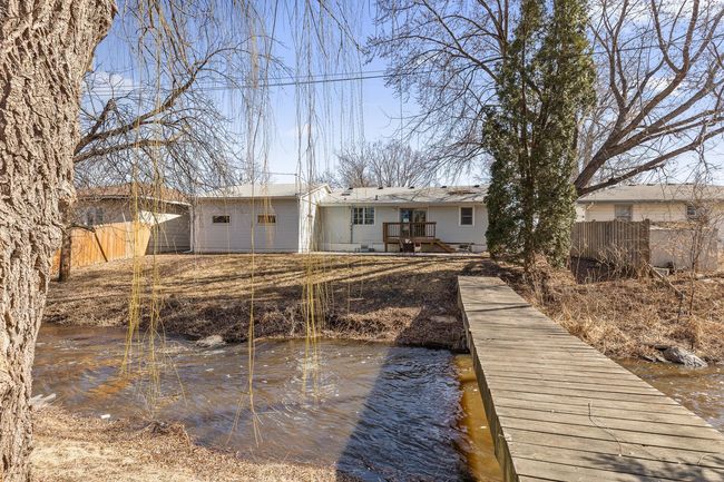 View of the back of the property and walking bridge with credit river right in your back yard. | Image 23