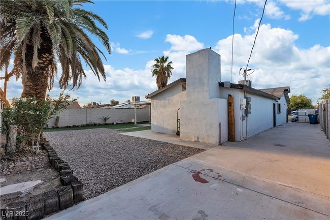 View of side of property with stucco siding, a patio, and a fenced backyard | Image 43