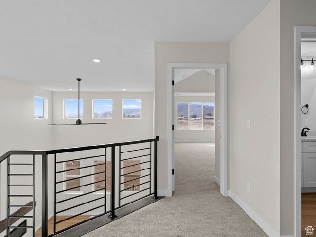 Hall with light carpet, baseboards, an upstairs landing, a sink, and recessed lighting | Image 24