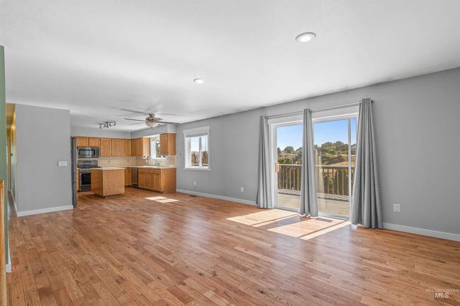 Unfurnished living room with light wood finished floors, ceiling fan, and recessed lighting | Image 6