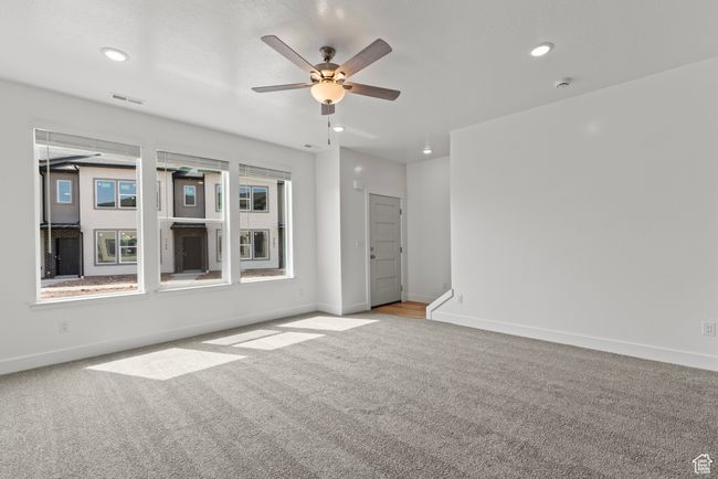 Carpeted spare room with ceiling fan, baseboards, visible vents, and recessed lighting | Image 6