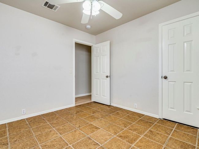 Spare room with ceiling fan and baseboards | Image 21