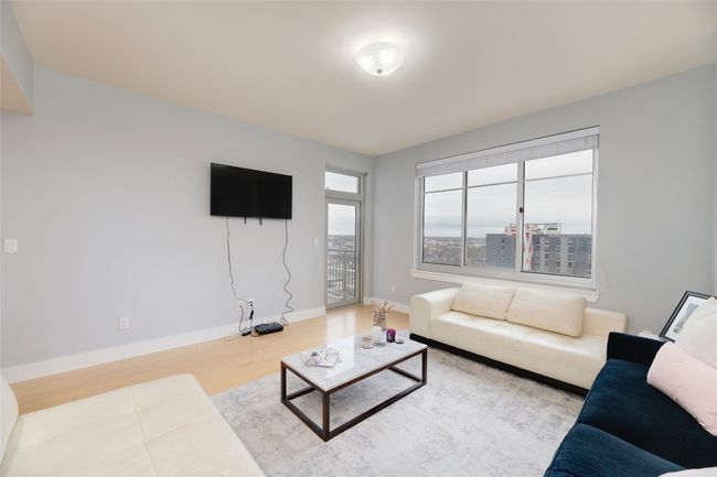 Living area with wood finished floors and baseboards | Image 5