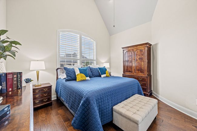 Bedroom with high vaulted ceiling, wood-flooring, and baseboards | Image 13