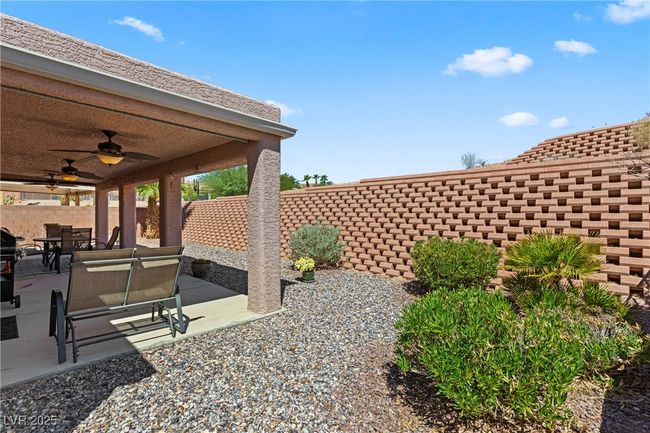 Fenced backyard featuring a ceiling fan, a patio, and outdoor dining area | Image 46
