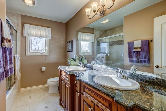 Full bath on upper level with granite counters and dual sinks | Image 30