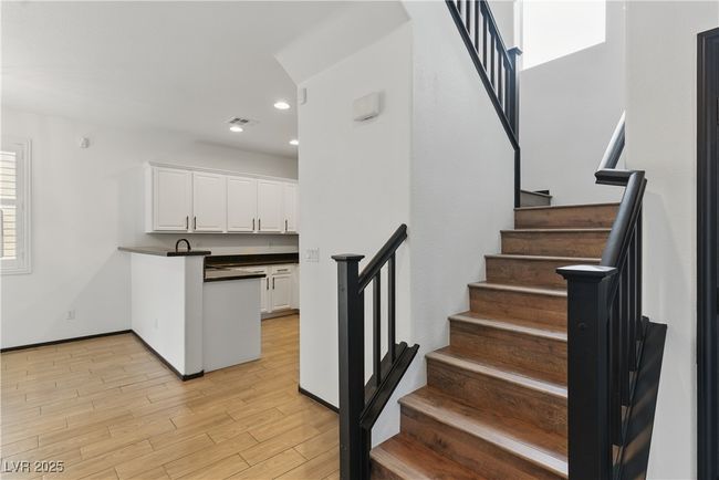 Hall leading to kitchen/dining area with view of the stairs | Image 8