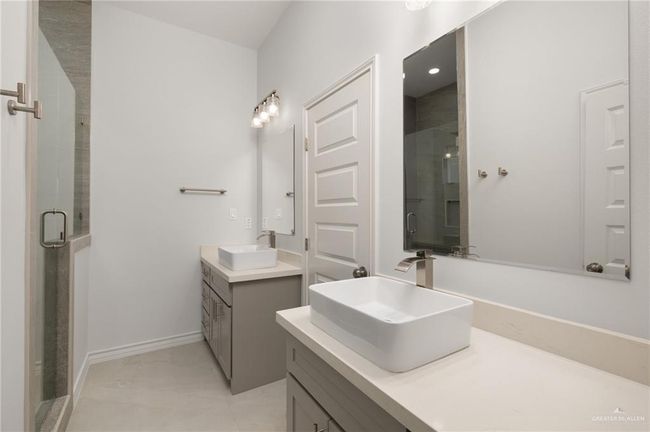 Full bath featuring two vanities and a stall shower | Image 11