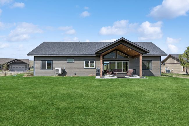 Back of property with a patio area, roof with shingles, an outdoor fire pit, and a lawn | Image 6