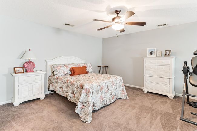 Bedroom featuring light carpet, baseboards, and visible vents | Image 21