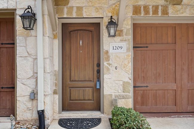1st Floor Exterior Entrance to property with solid wood door and stone siding | Image 35