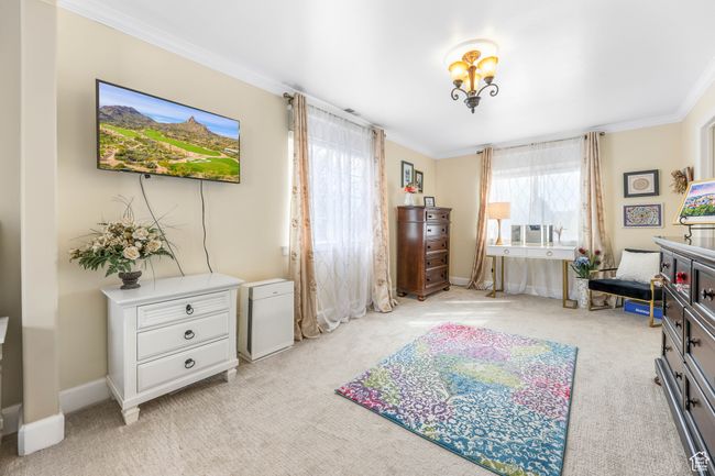 Bedroom with baseboards, ornamental molding, and light colored carpet | Image 25