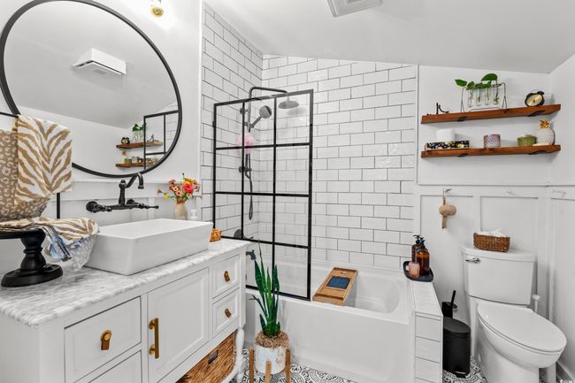 Bathroom featuring vanity and bathing tub / shower combination | Image 21