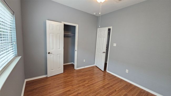 Unfurnished bedroom featuring wood finished floors and a closet | Image 9