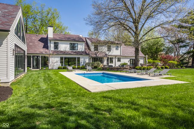 back of house with an outdoor pool, a patio area, a yard | Image 67