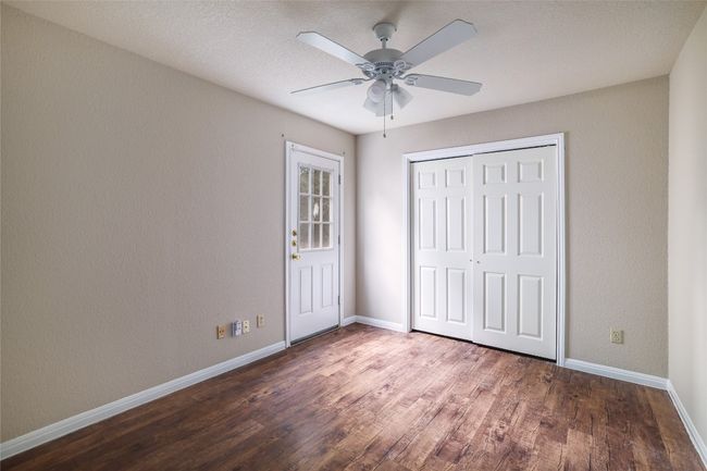 Unfurnished bedroom with baseboards, wood finished floors, a closet, and a ceiling fan | Image 10